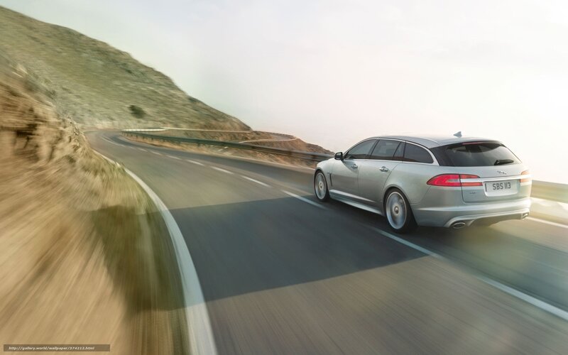 silver jaguar driving on mountain road