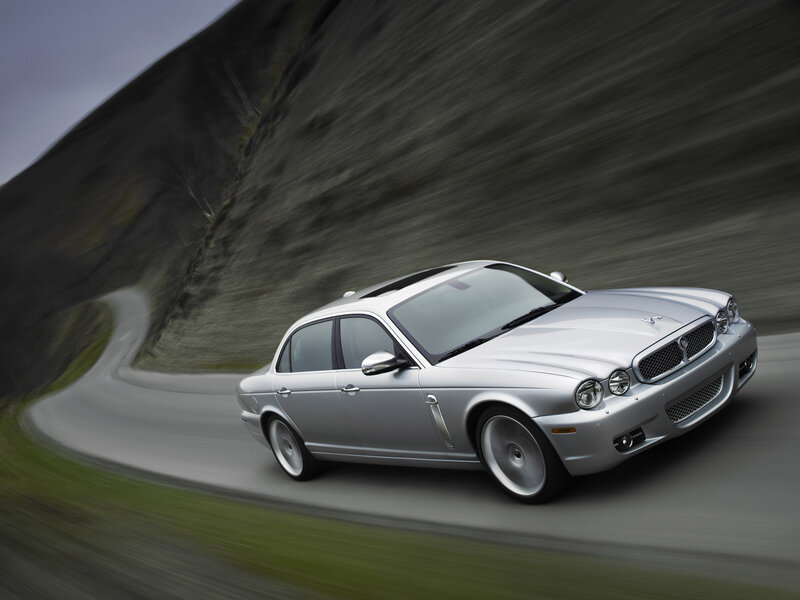 silver jaguar driving on road