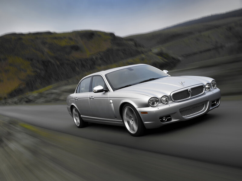 silver jaguar driving on road