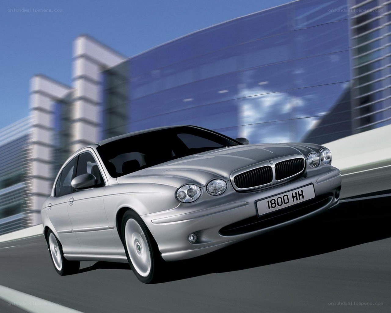 silver jaguar driving on road