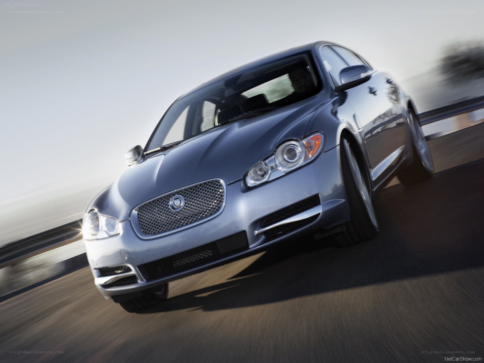 silver jaguar driving on road