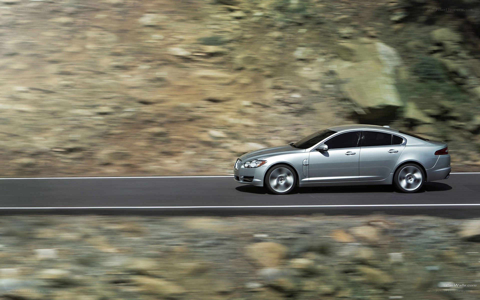 silver jaguar driving on road
