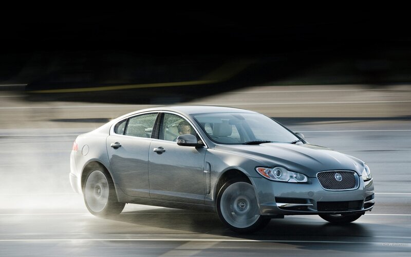 silver jaguar driving on road
