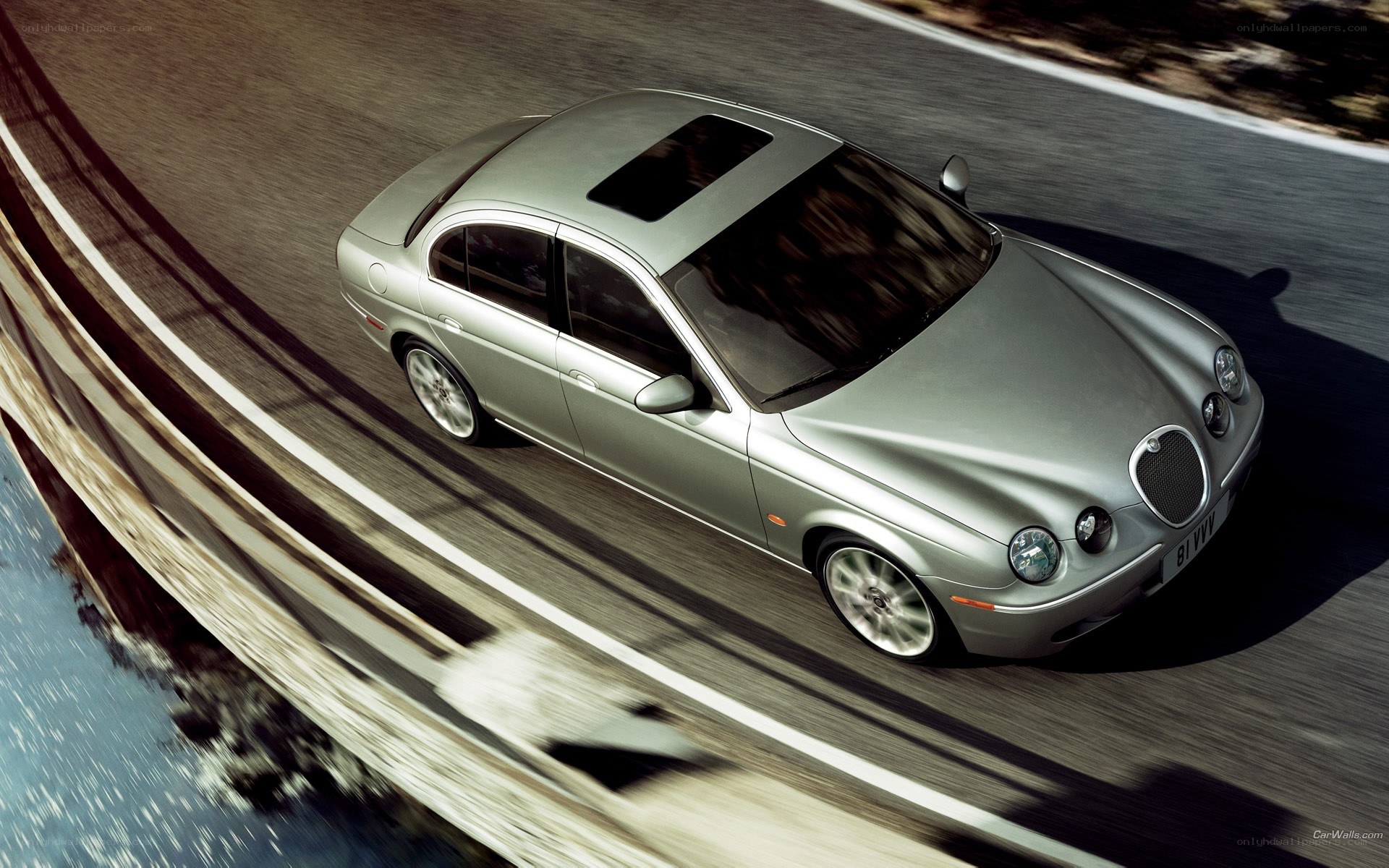 silver jaguar driving on road