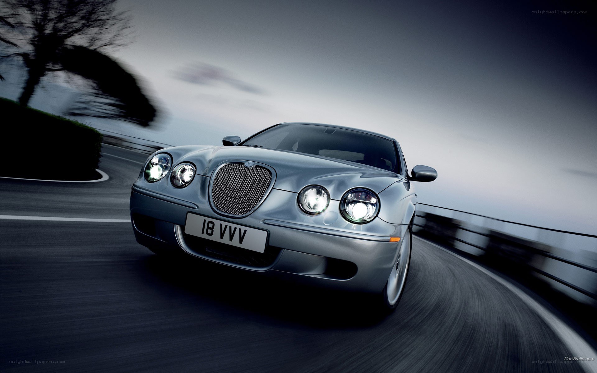 silver jaguar driving on road