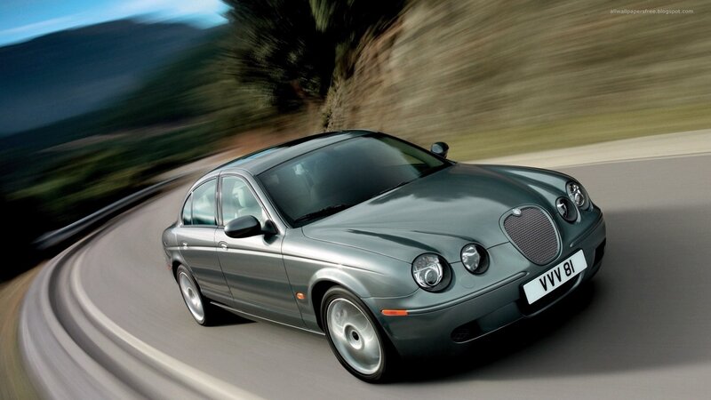 silver jaguar driving on road