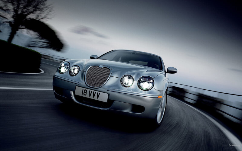 silver jaguar driving on road