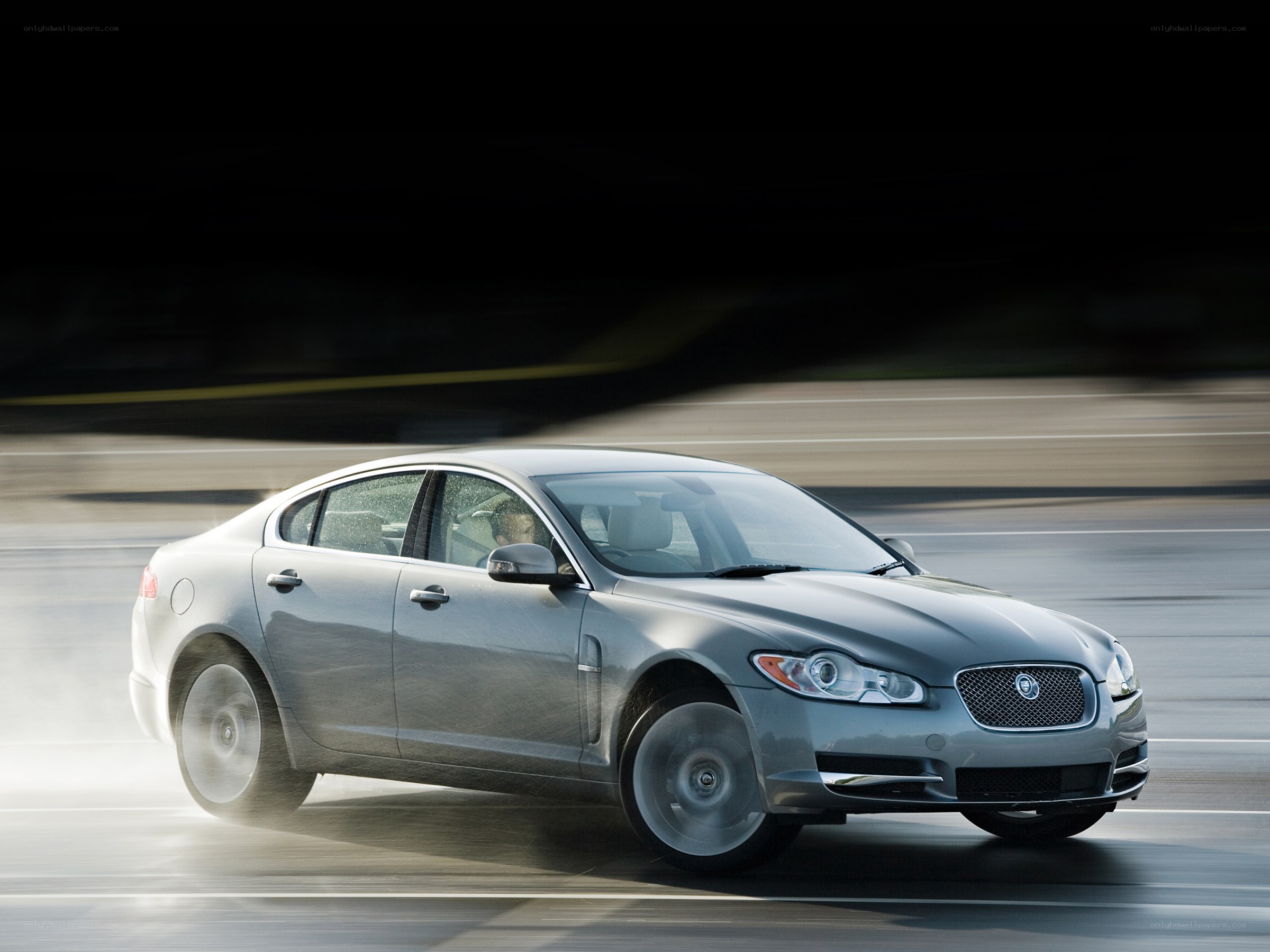 silver jaguar driving on road