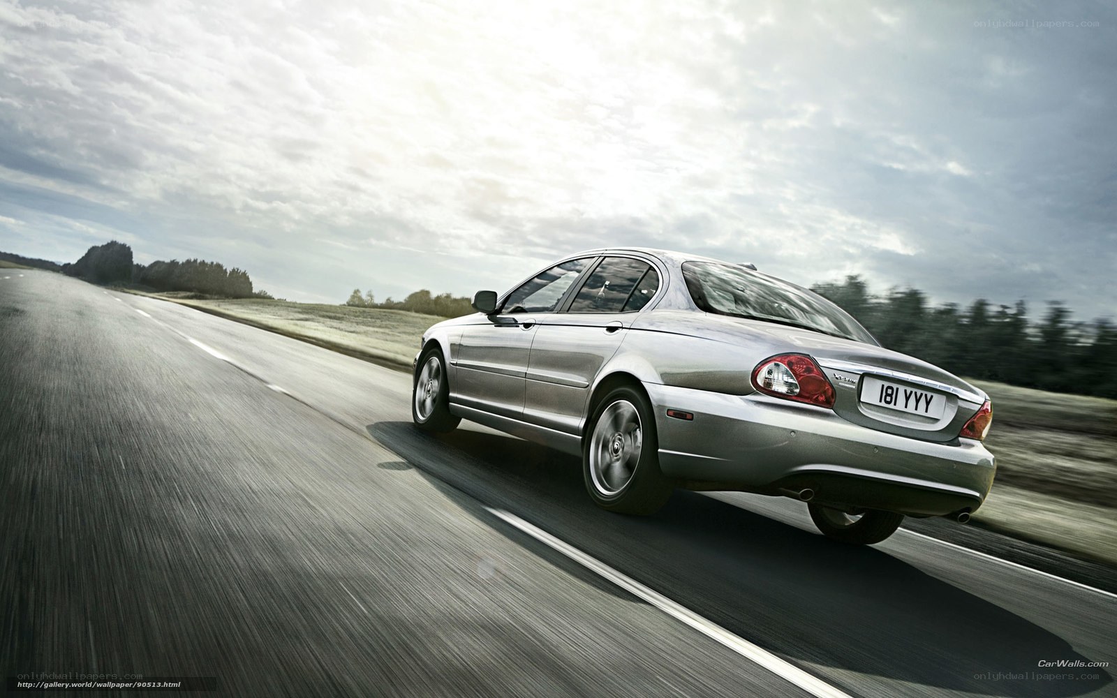 silver jaguar driving on road