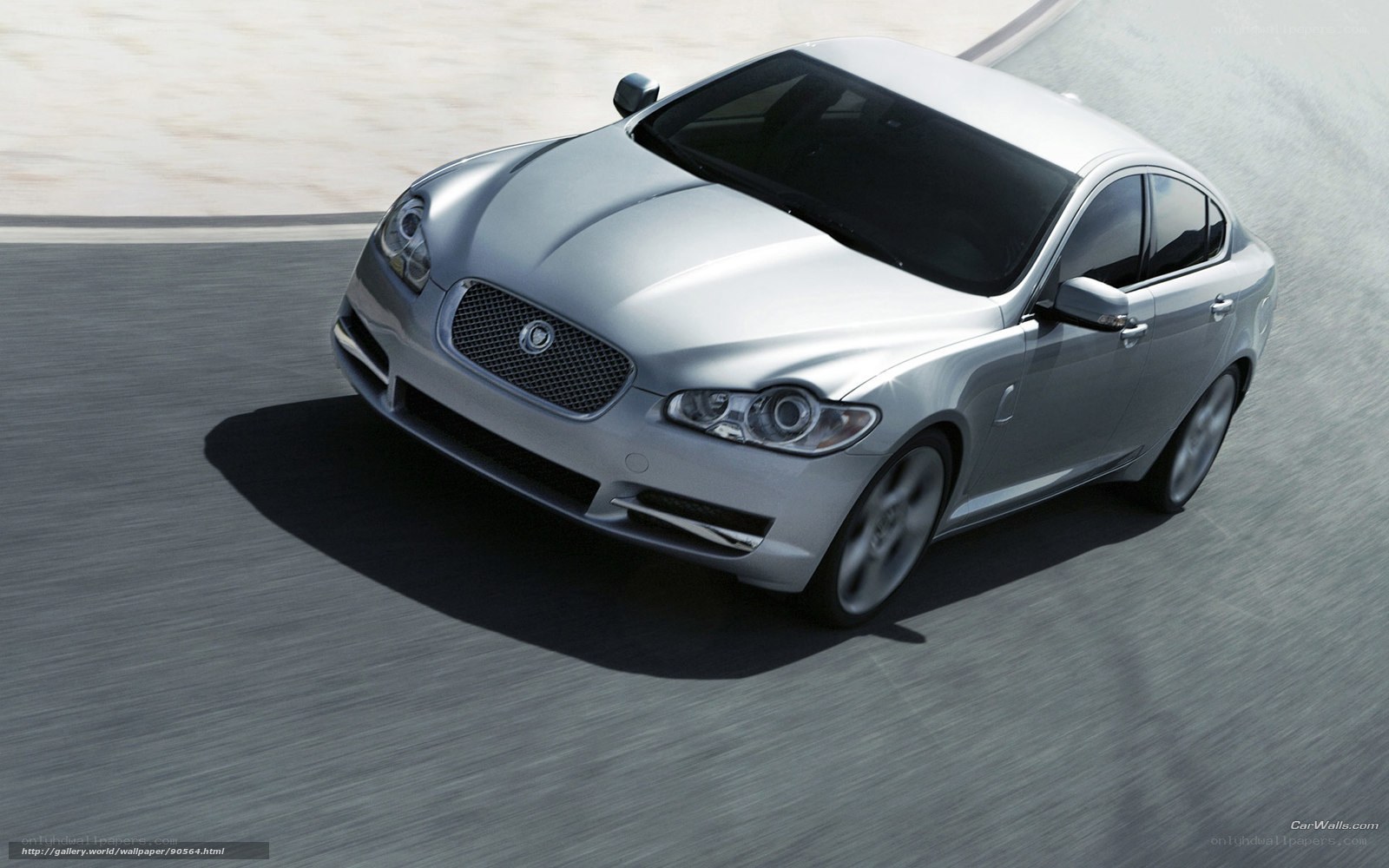 silver jaguar driving on track