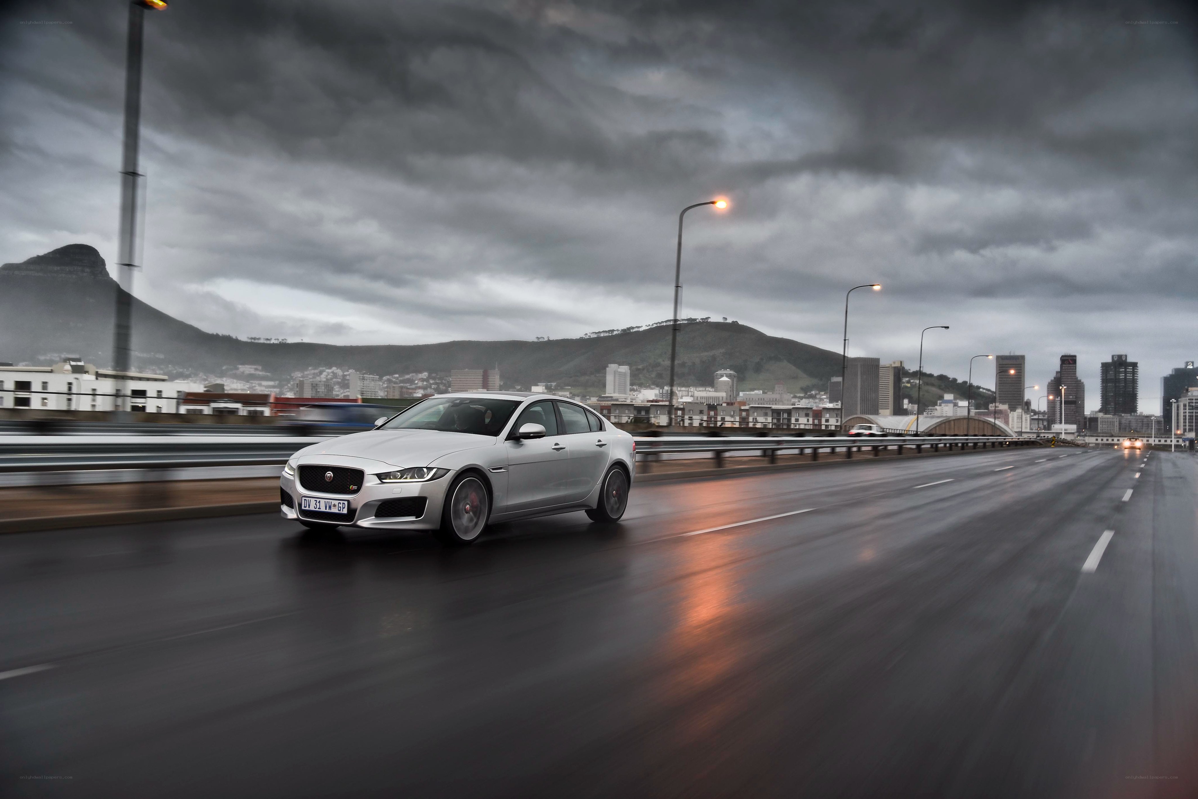 Silver Jaguar on a wet bridge