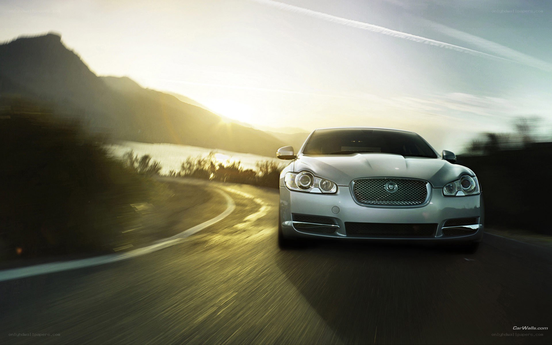 Silver Jaguar on a winding road