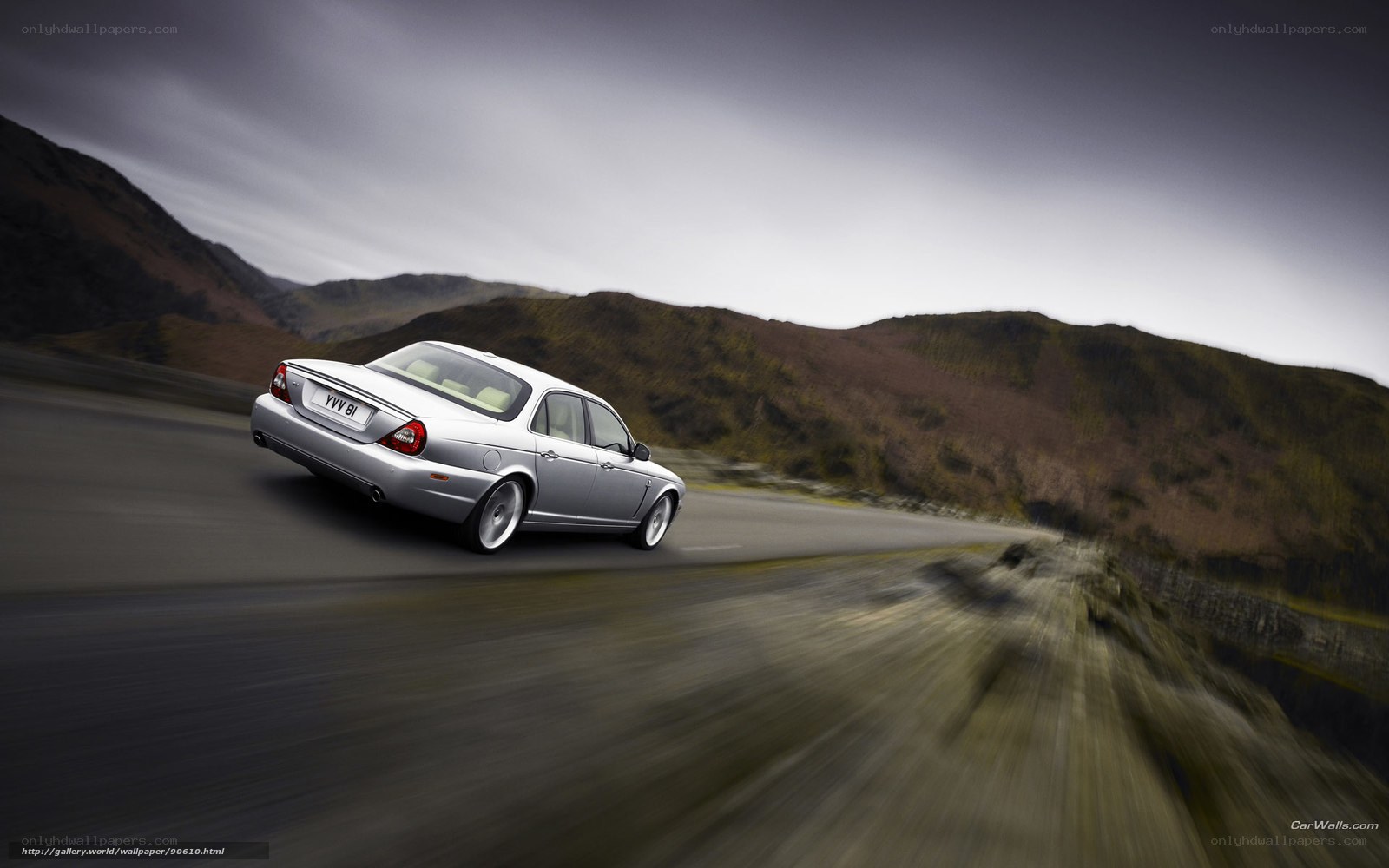silver jaguar on mountain road