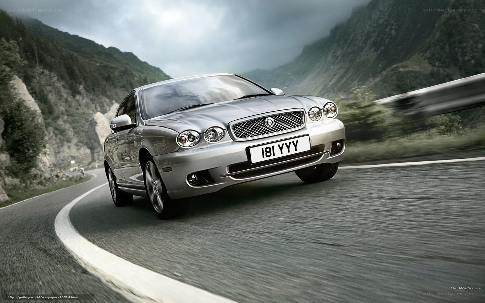 silver jaguar on mountain road