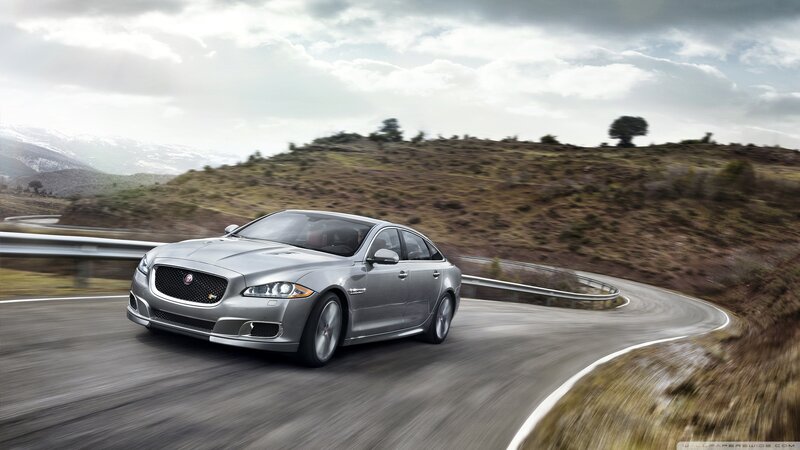 silver jaguar on winding road