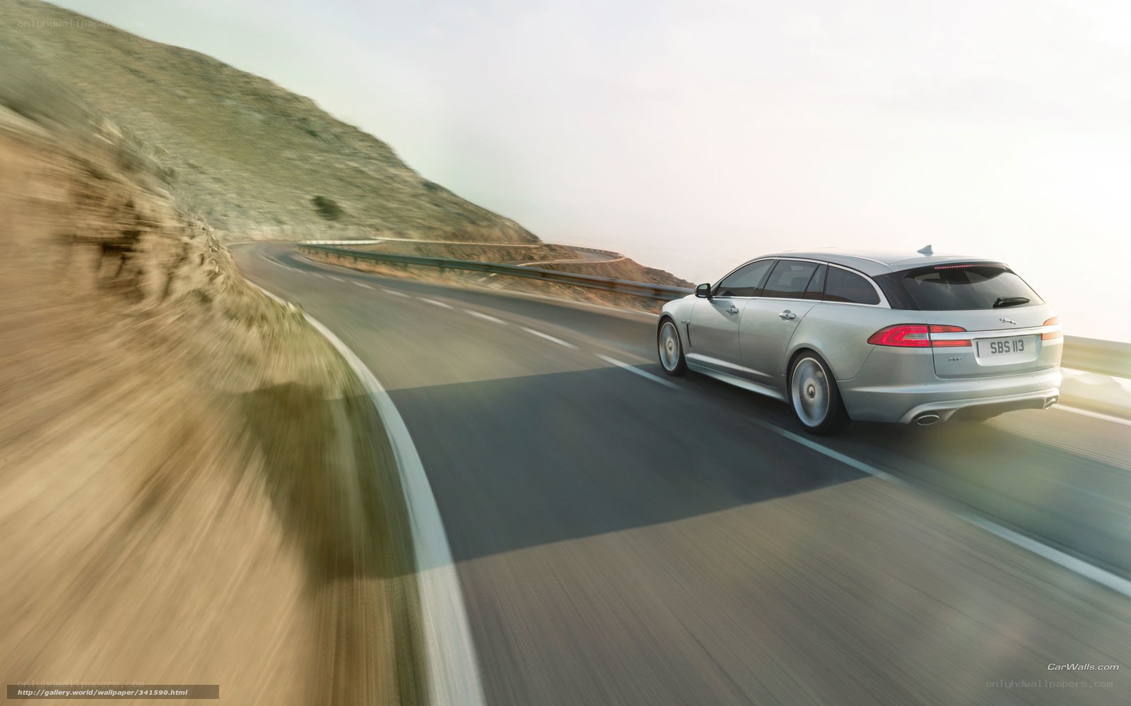 silver jaguar on winding road