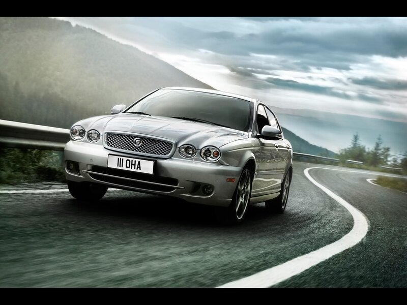 silver jaguar on winding road