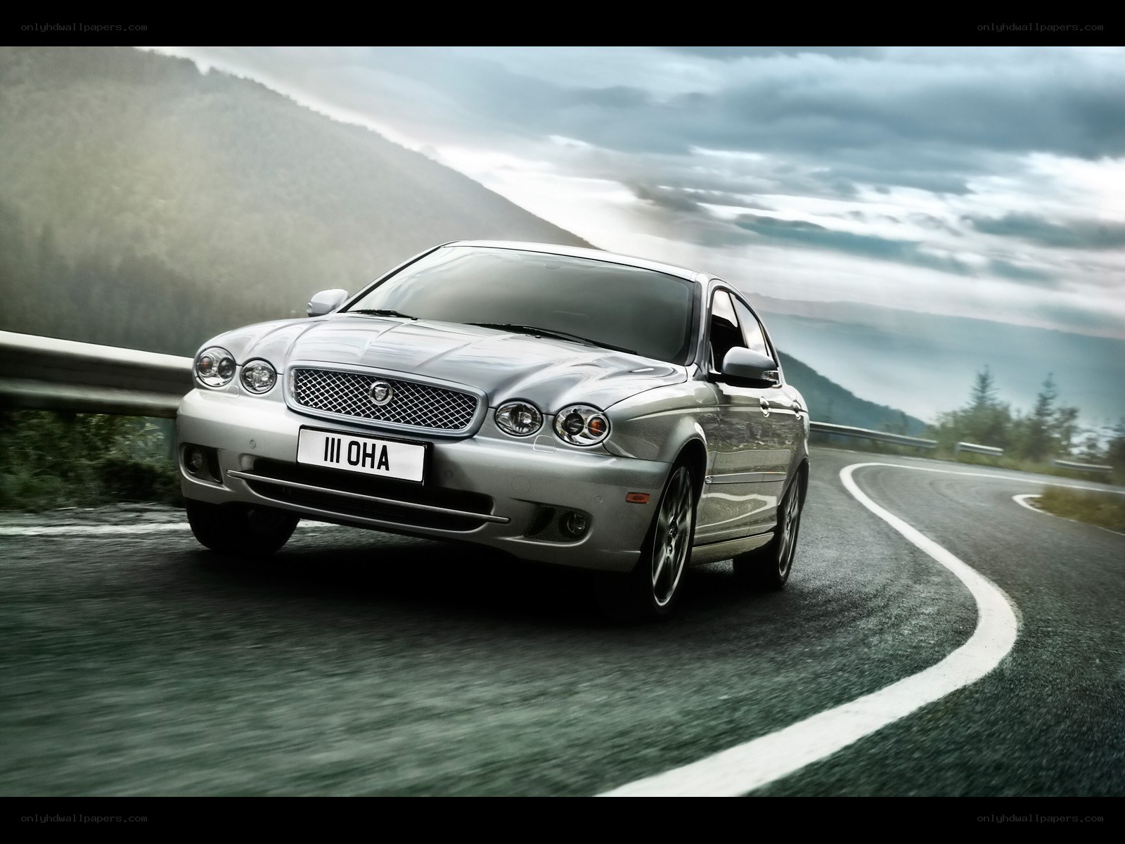 silver jaguar on winding road