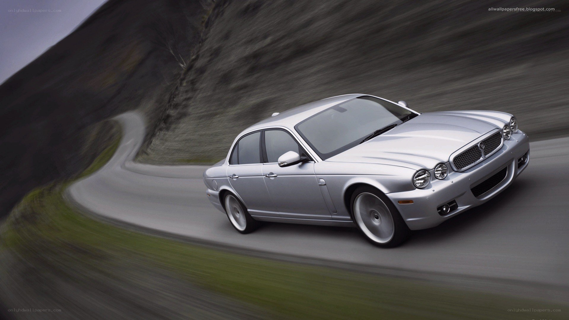 silver jaguar on winding road