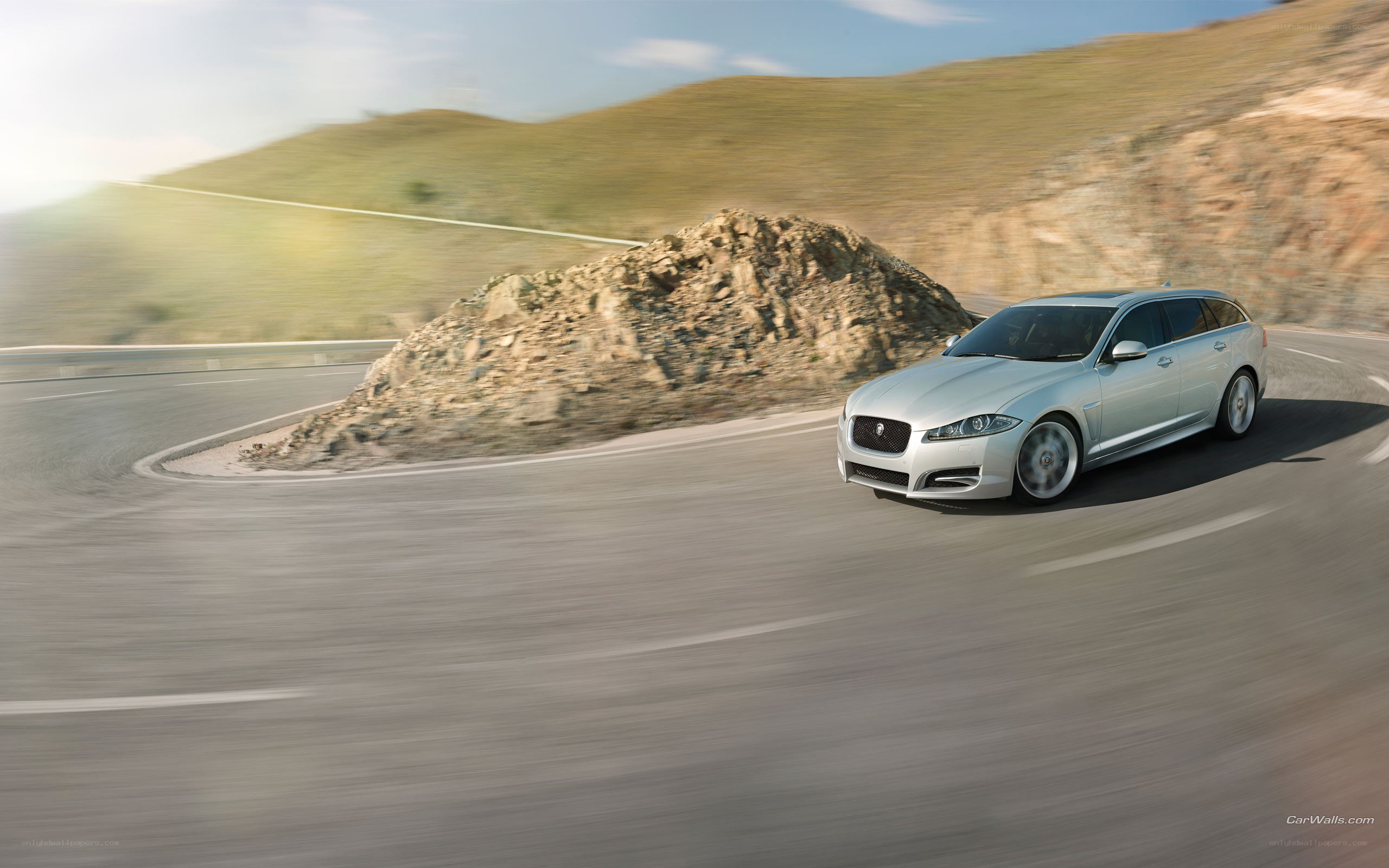 silver jaguar on winding road