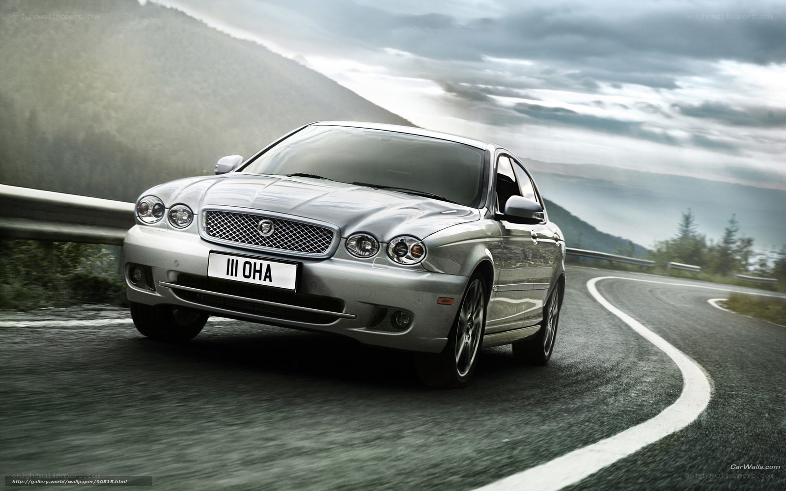 silver jaguar on winding road