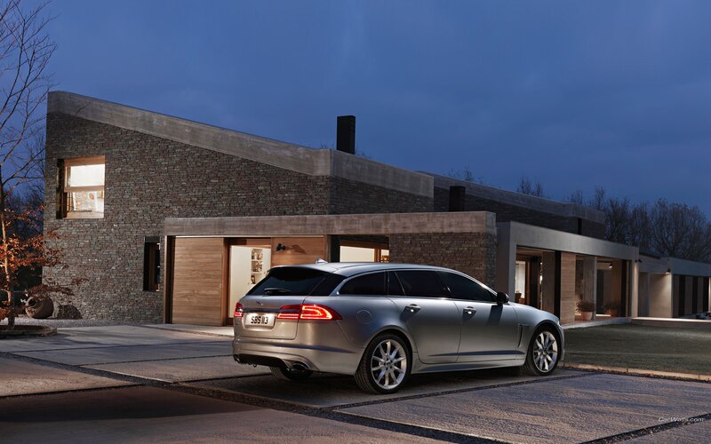 Silver Jaguar parked at modern home