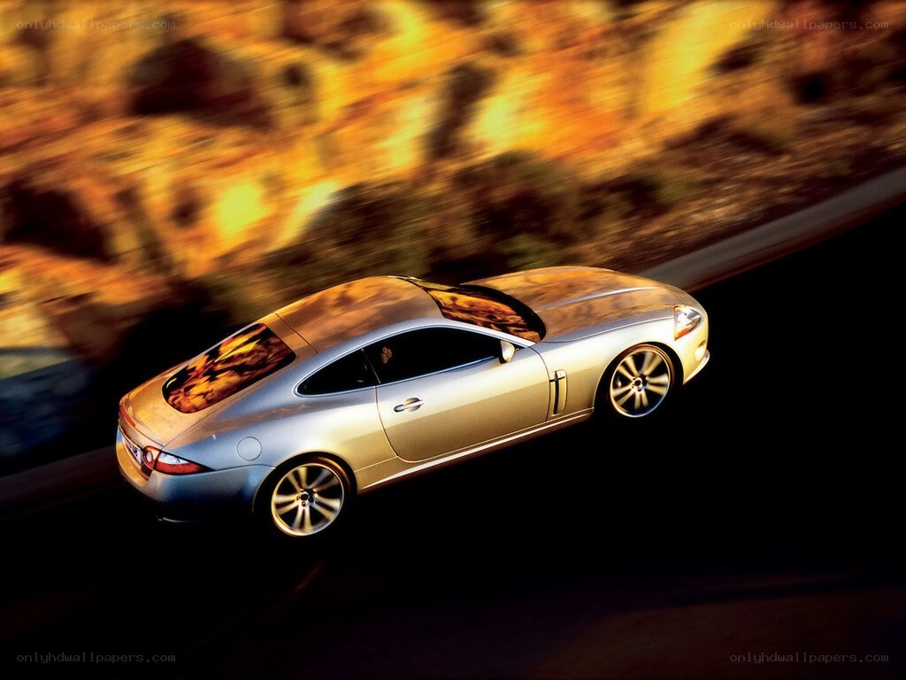 silver jaguar speeding on road