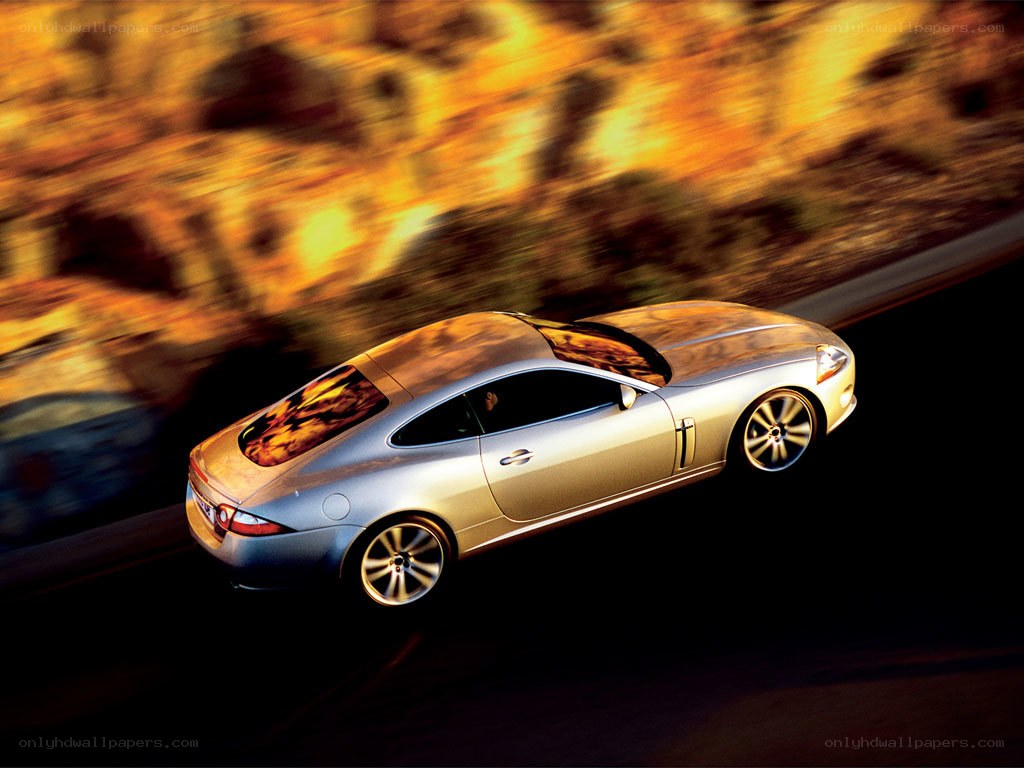 silver jaguar speeding on road