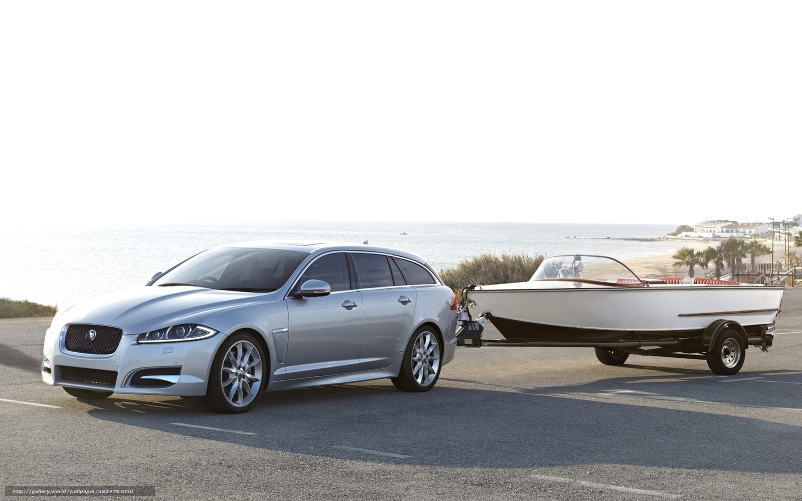 Silver Jaguar towing a boat