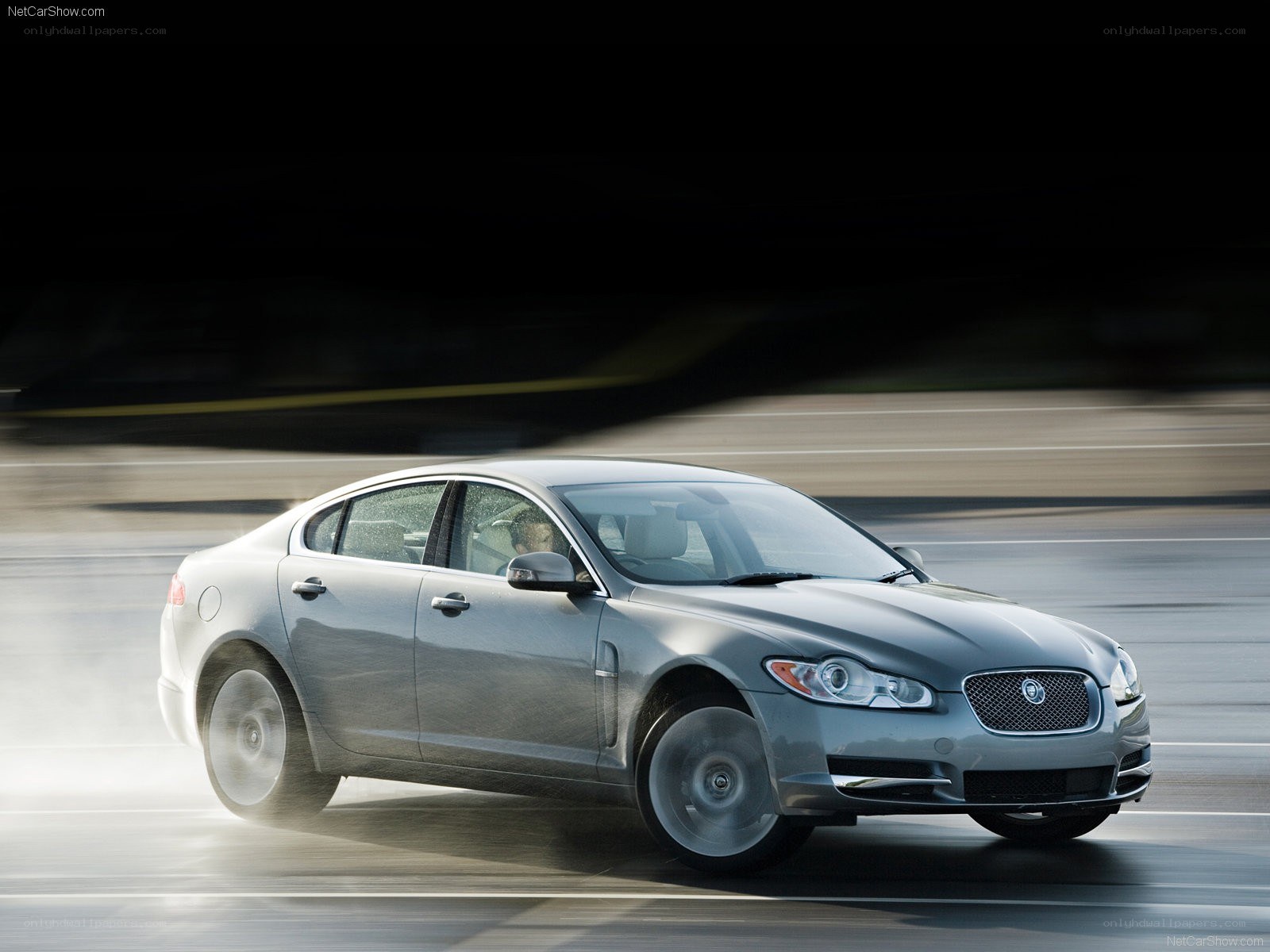 silver jaguar xf in motion