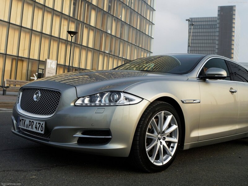 silver jaguar xj parked in city