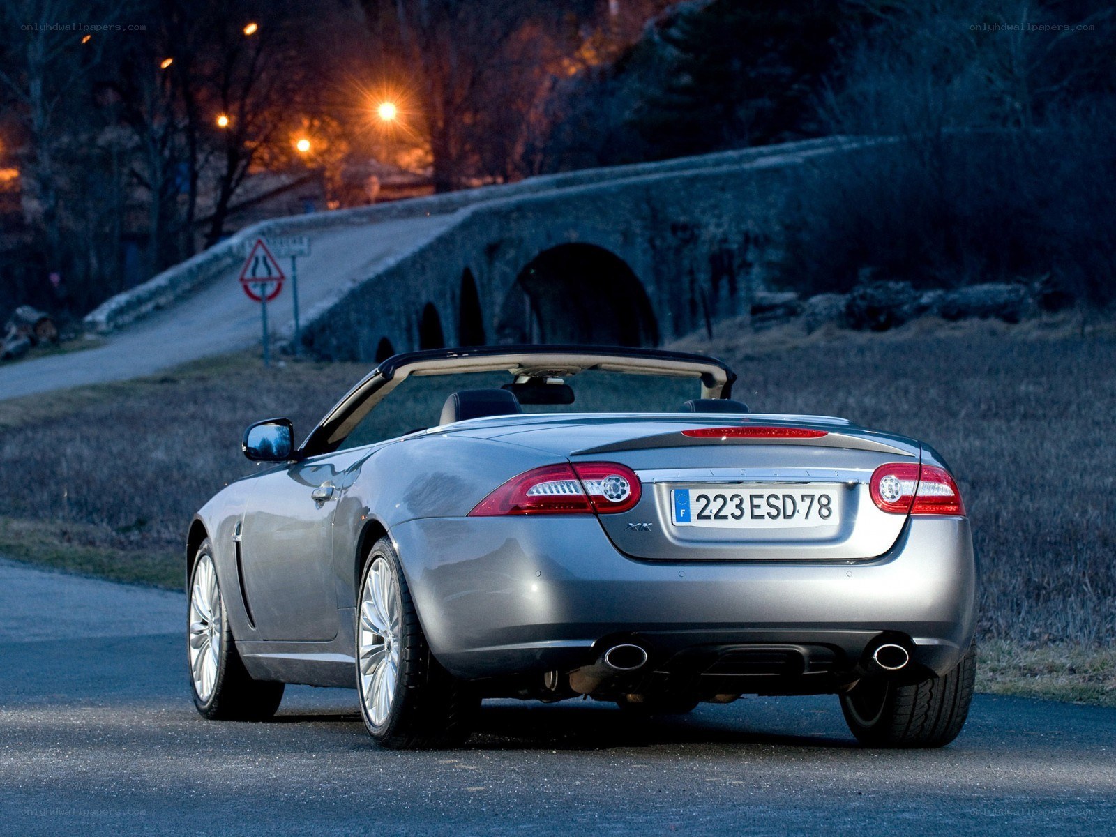 Silver Jaguar XK convertible at night