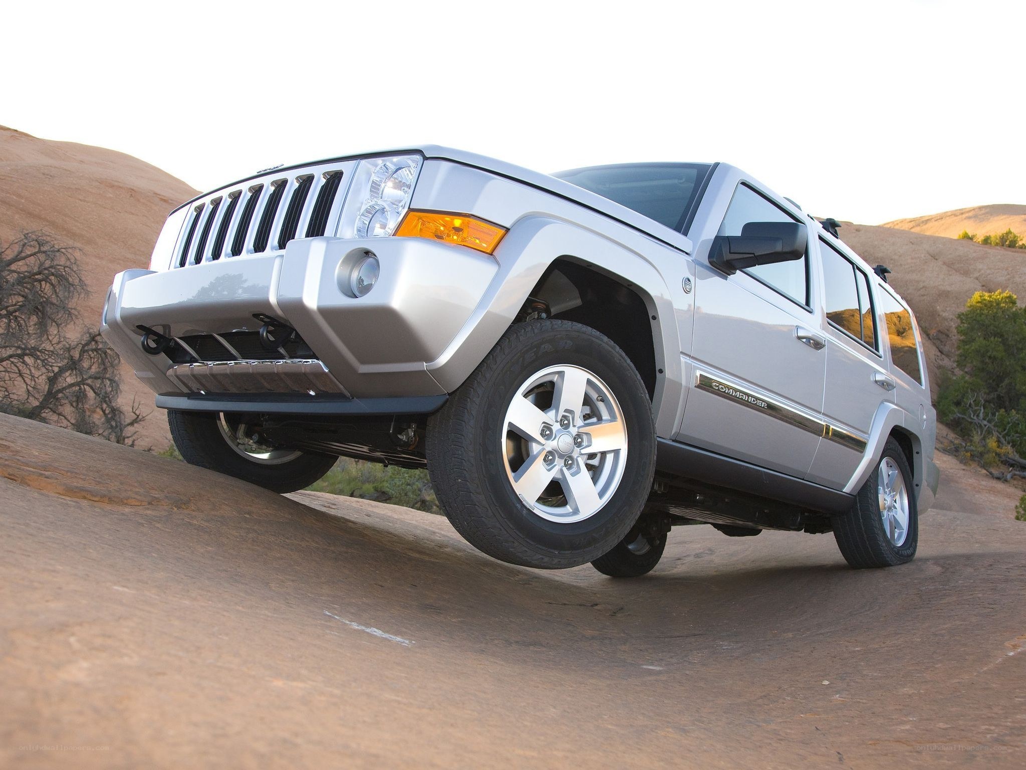Silver Jeep Commander on a rock