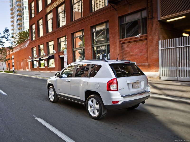 Silver Jeep Compass driving on city street