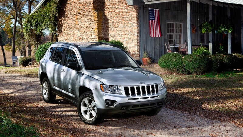 Silver Jeep Compass in front of house