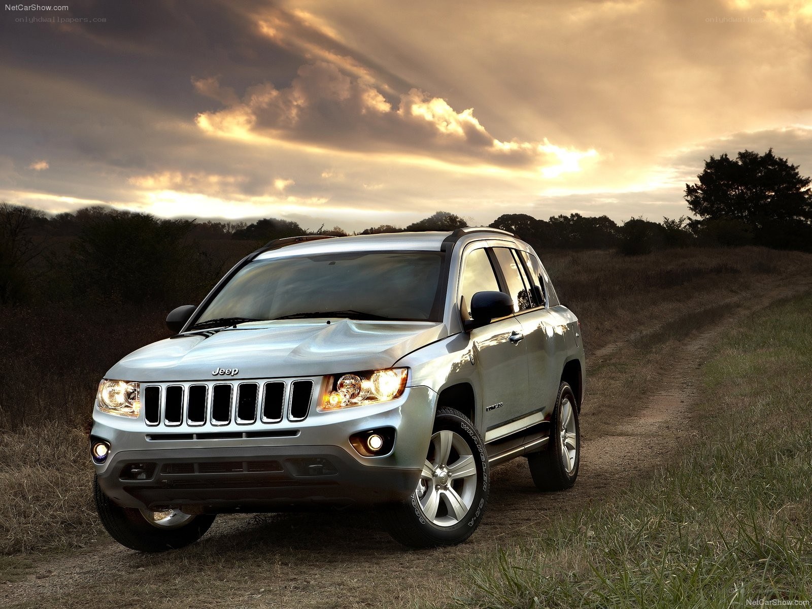 Silver Jeep Compass on a dirt road