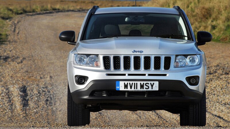 silver jeep compass on gravel