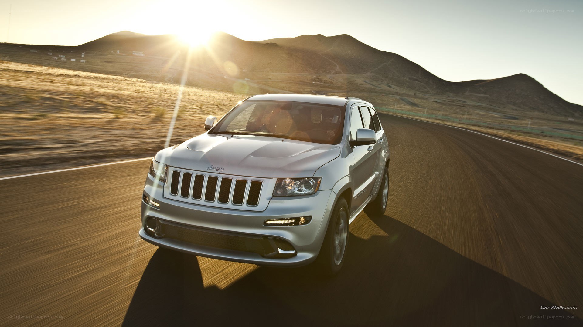 silver jeep driving on desert road