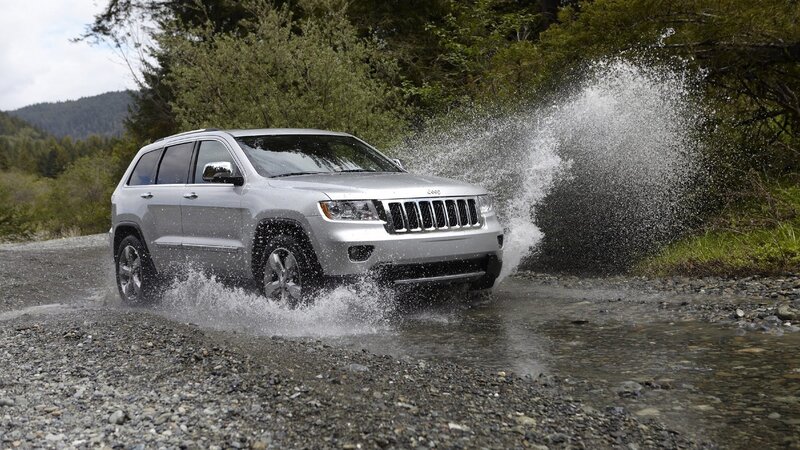 silver jeep driving through water