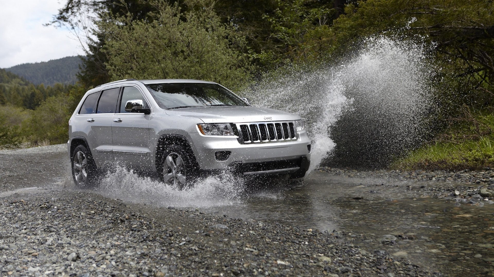 silver jeep driving through water
