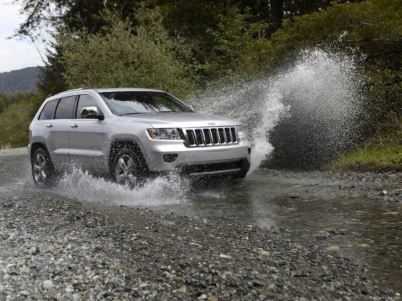 Silver Jeep driving through water
