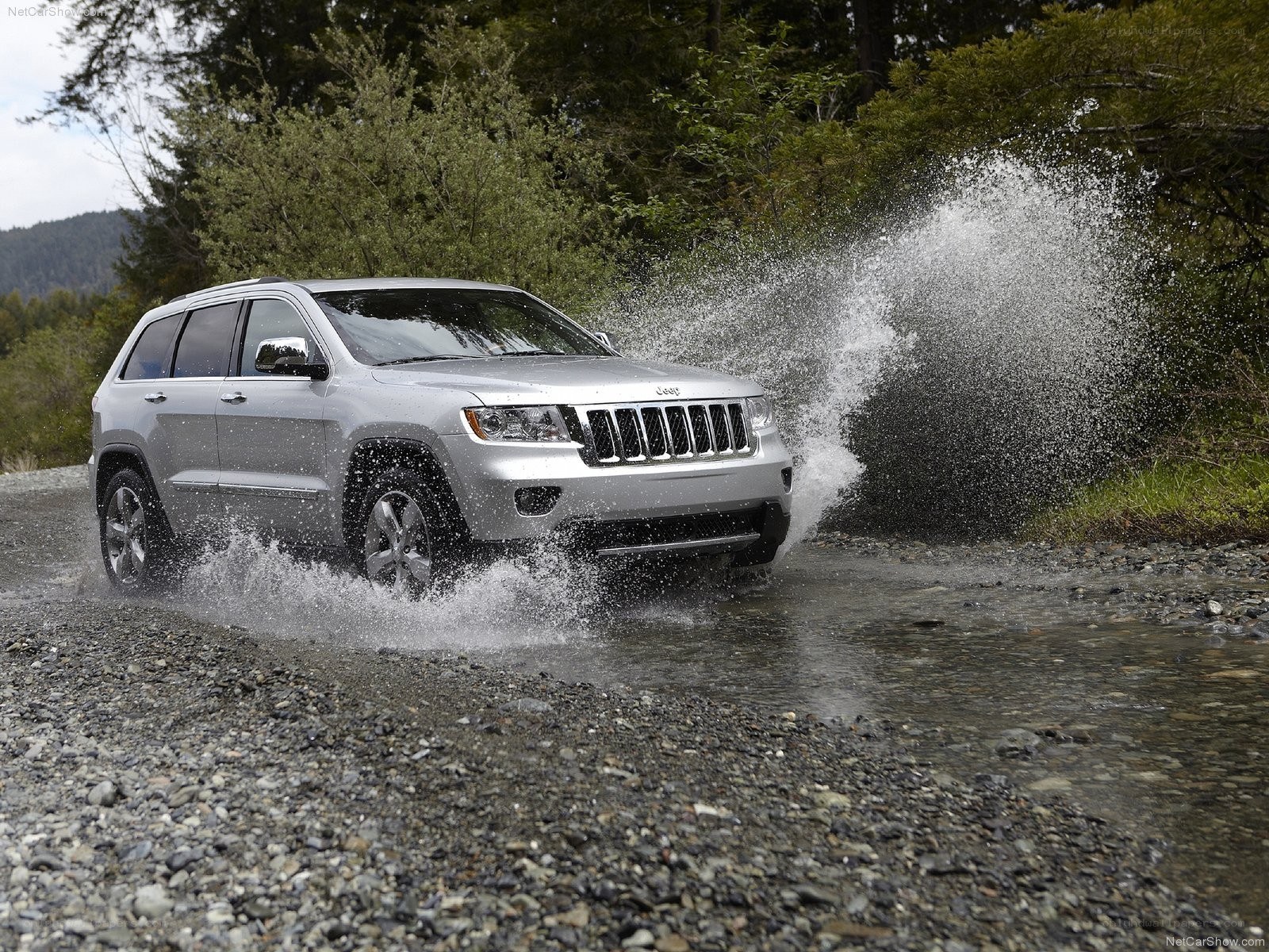 Silver Jeep driving through water