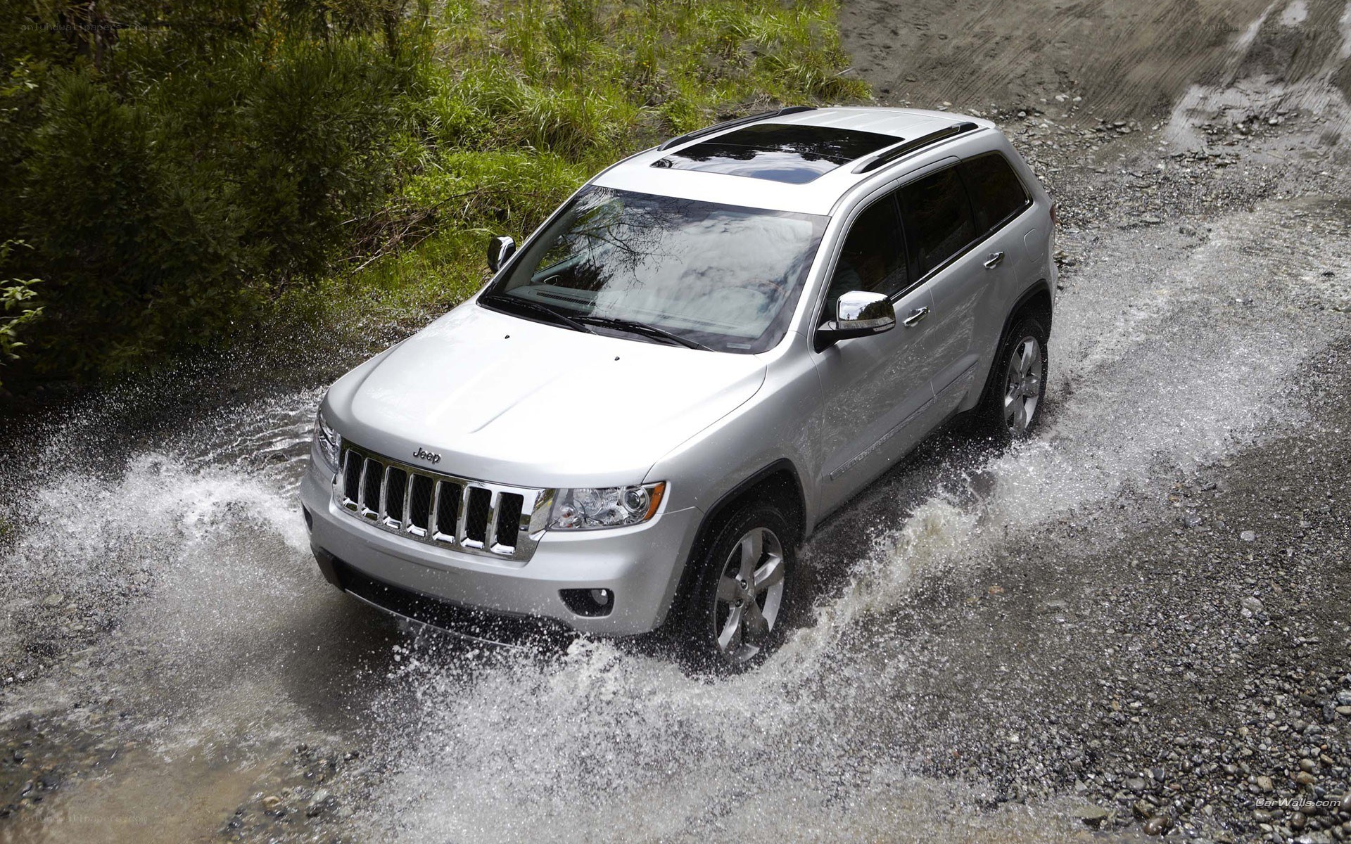 silver jeep driving through water