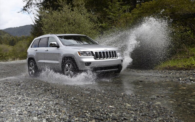Silver Jeep driving through water