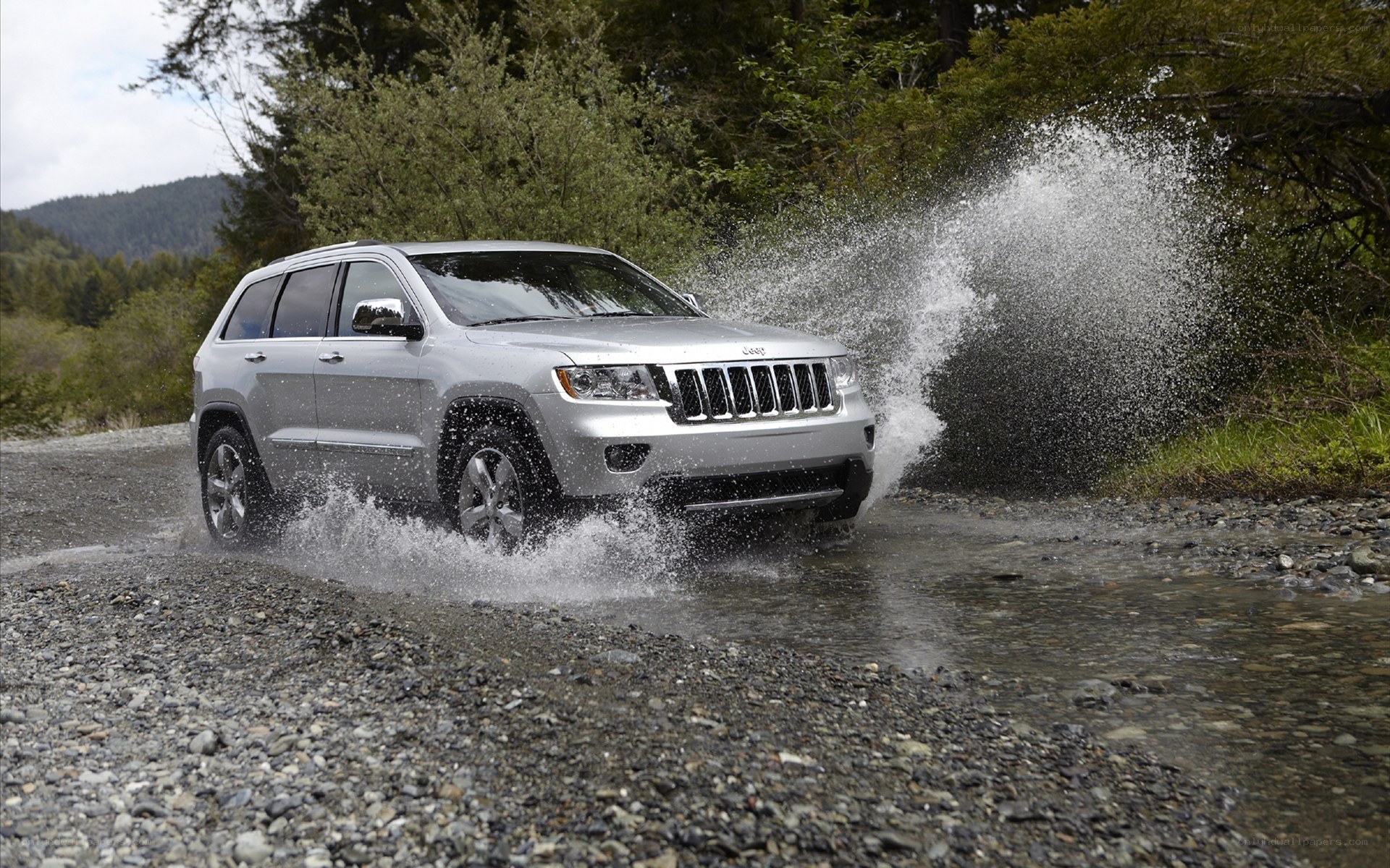 Silver Jeep driving through water