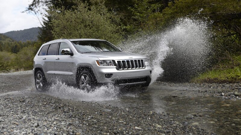 Silver Jeep driving through water