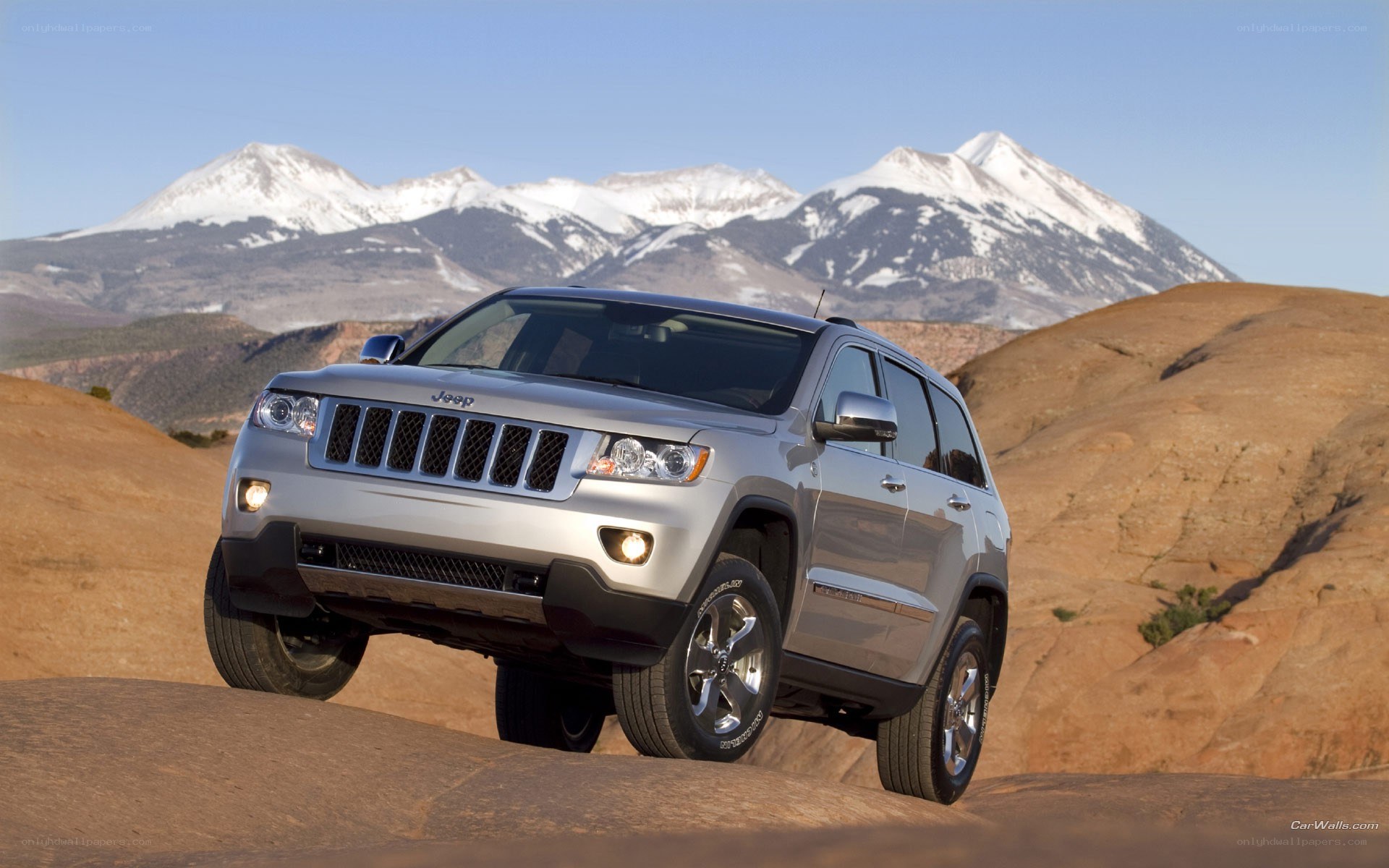 Silver Jeep in desert landscape