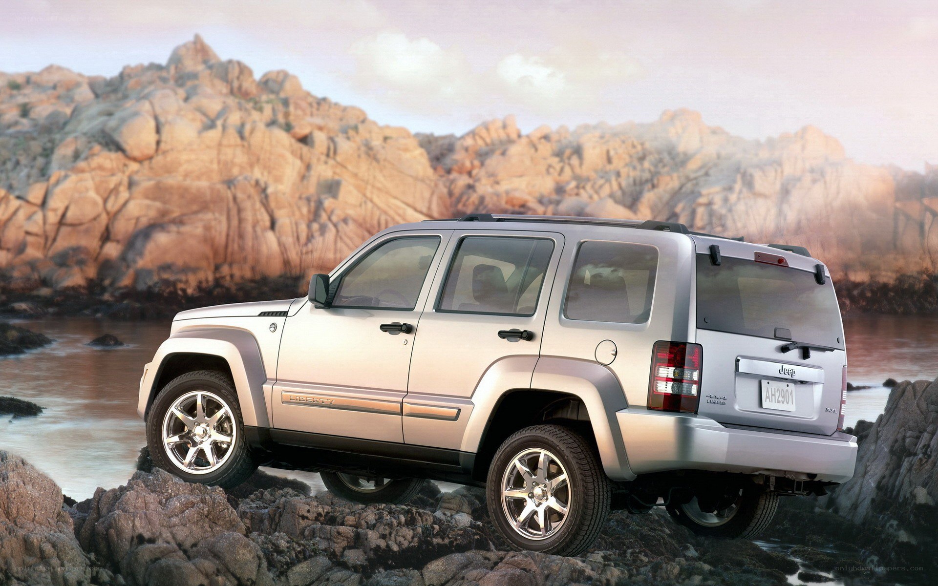 Silver Jeep Liberty on rocks