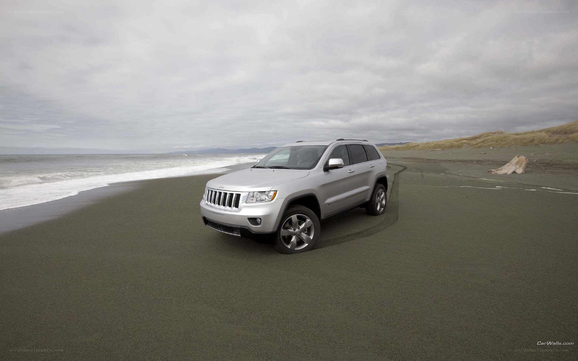 Silver Jeep on a beach