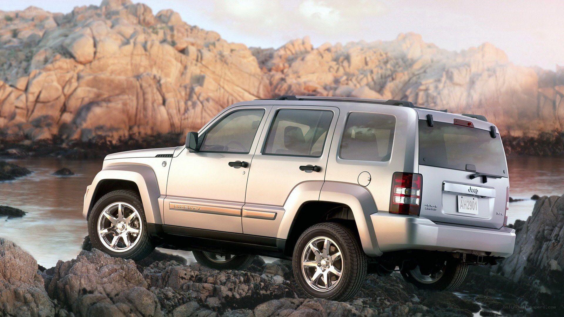 silver jeep on rocky shore